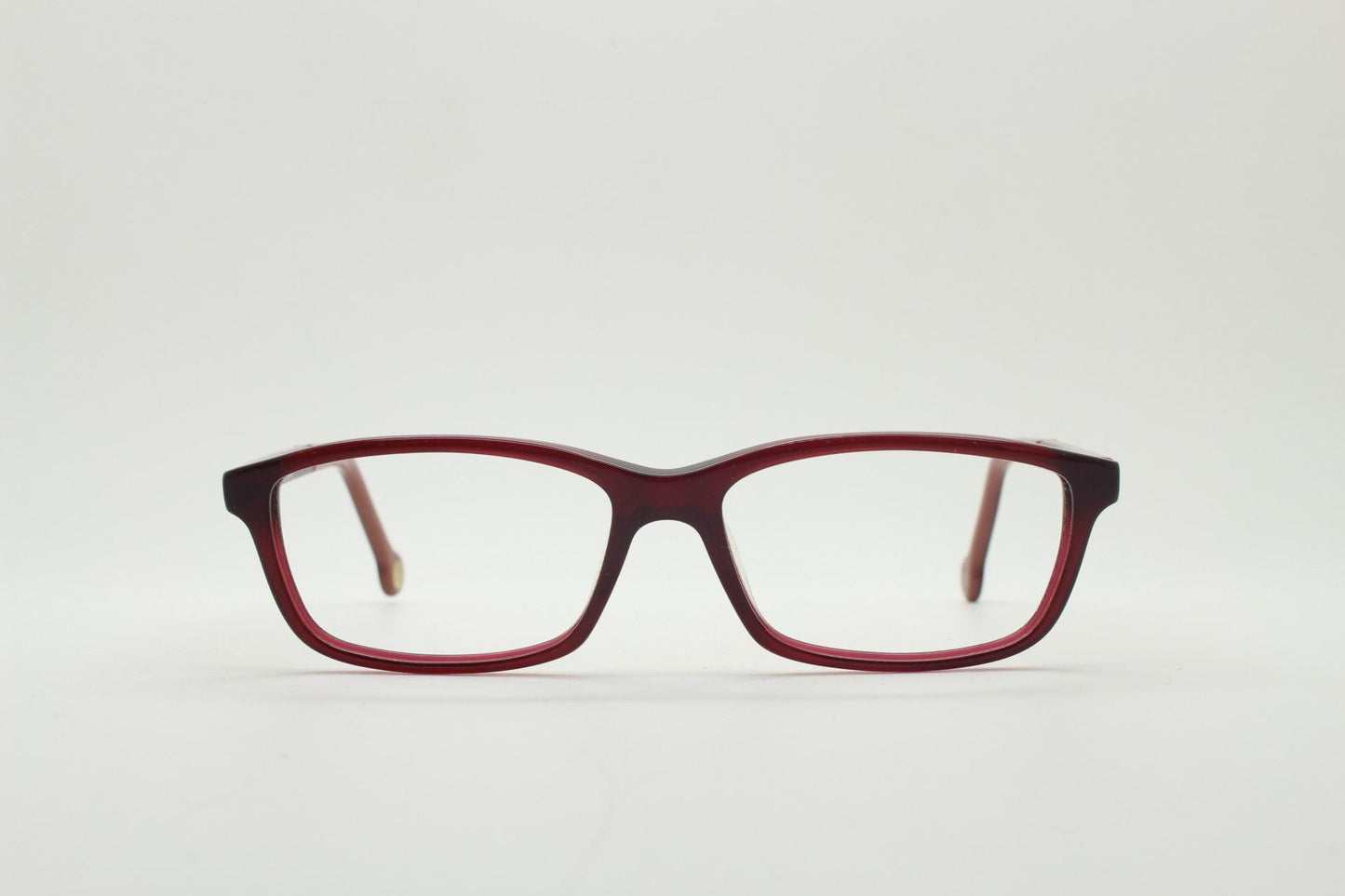 Carolina Herrera rectangular low profile eye glasses. Dark pink acetate optical frames with tasteful arm logo. Prescription RX eyeglasses
