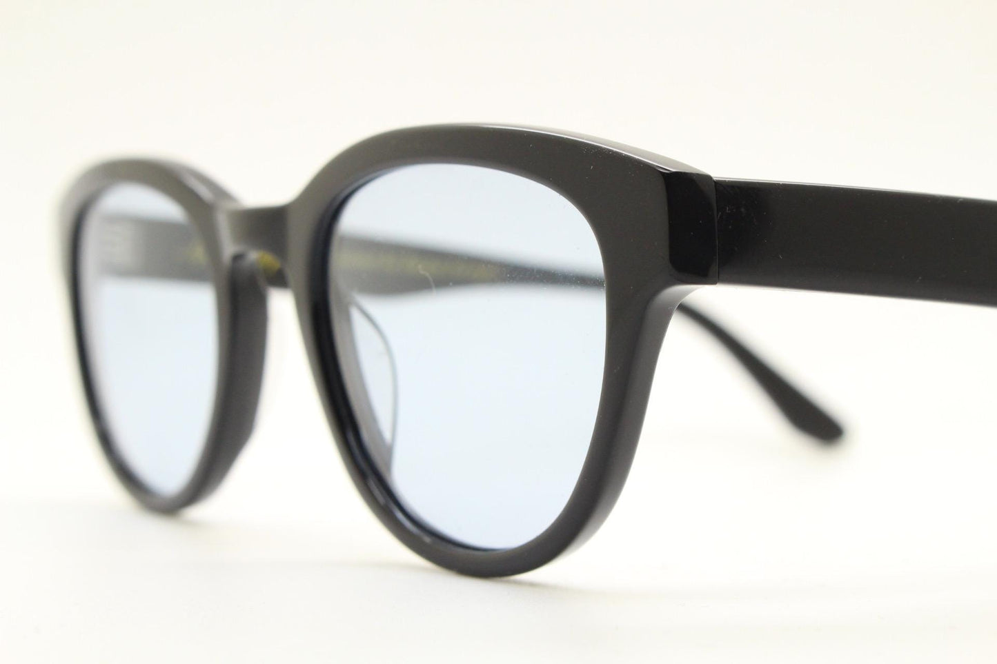 Vintage modified wayfarer design sunglasses. Black gloss acetate frame with extra light tone blue lenses in ideal proportions. NOS