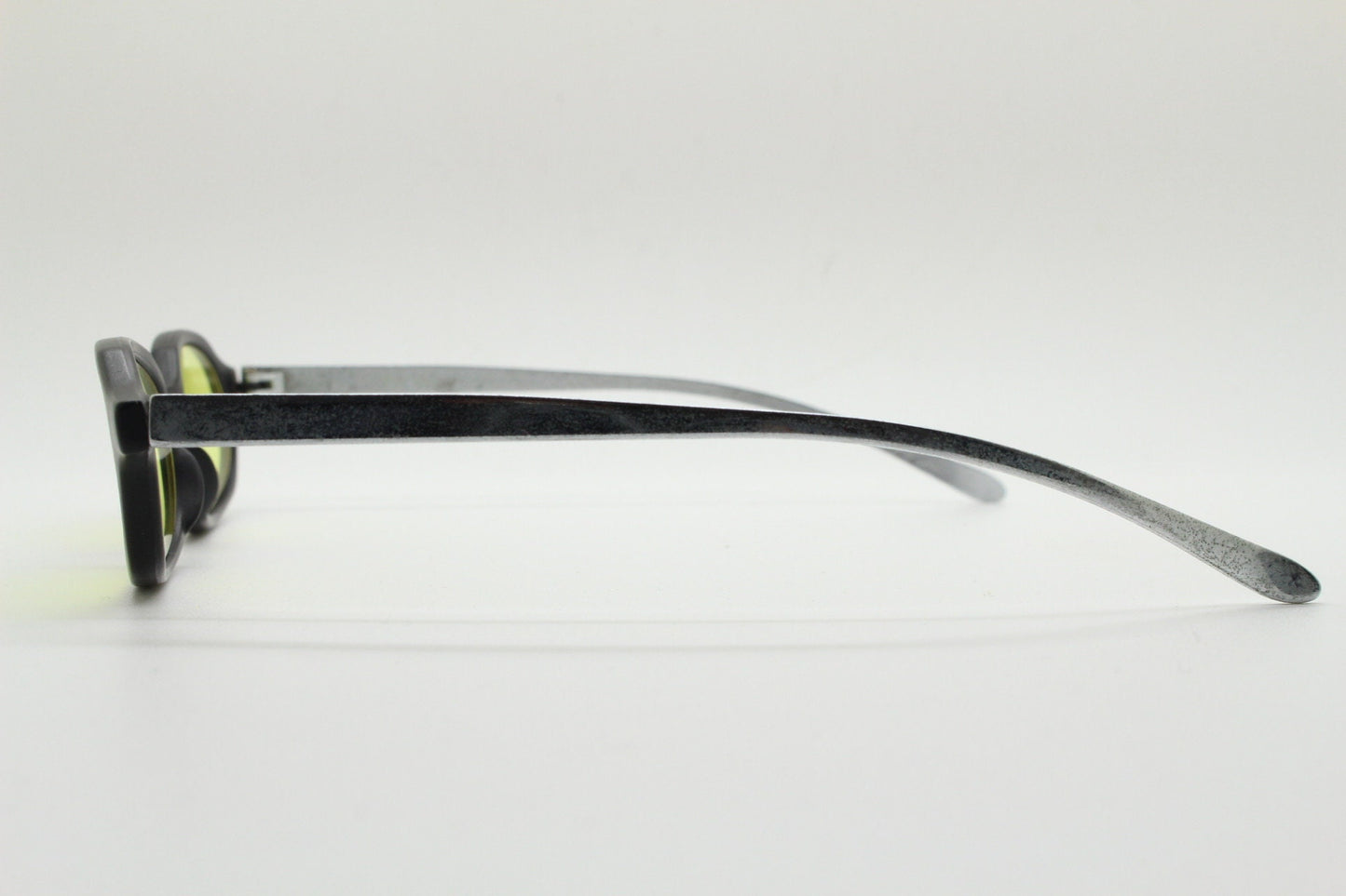 Vintage 90s oval sunglasses. Black low profile matt finish front with yellow lenses and silver chrome arms. Micro