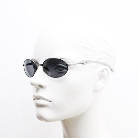 90s vintage small oval  bug eye sunglasses. Brushed bronze finish frame with transparent grey arms. Y2K. 2000s. Unworn NOS