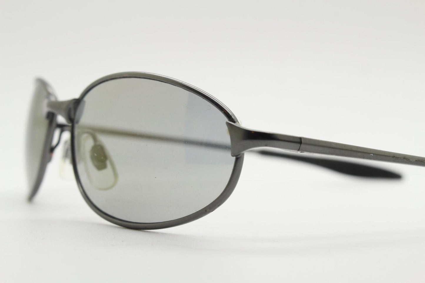 90s vintage oval small  bug eye sunglasses. Satin finish frame in gunmetal with straight spear arms. Y2K. 2000s. Unworn NOS