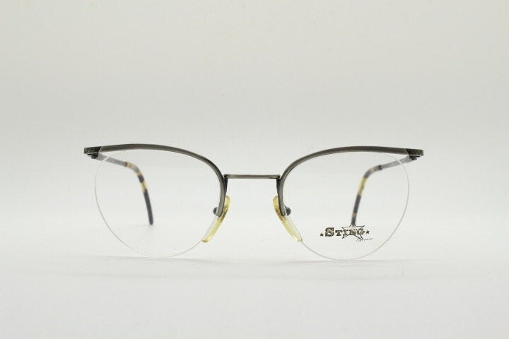 Sting 90s vintage round eye glasses. Minimal pewter finish metal half frame brow line optical frames. Prescription eyeglasses. RX. NOS
