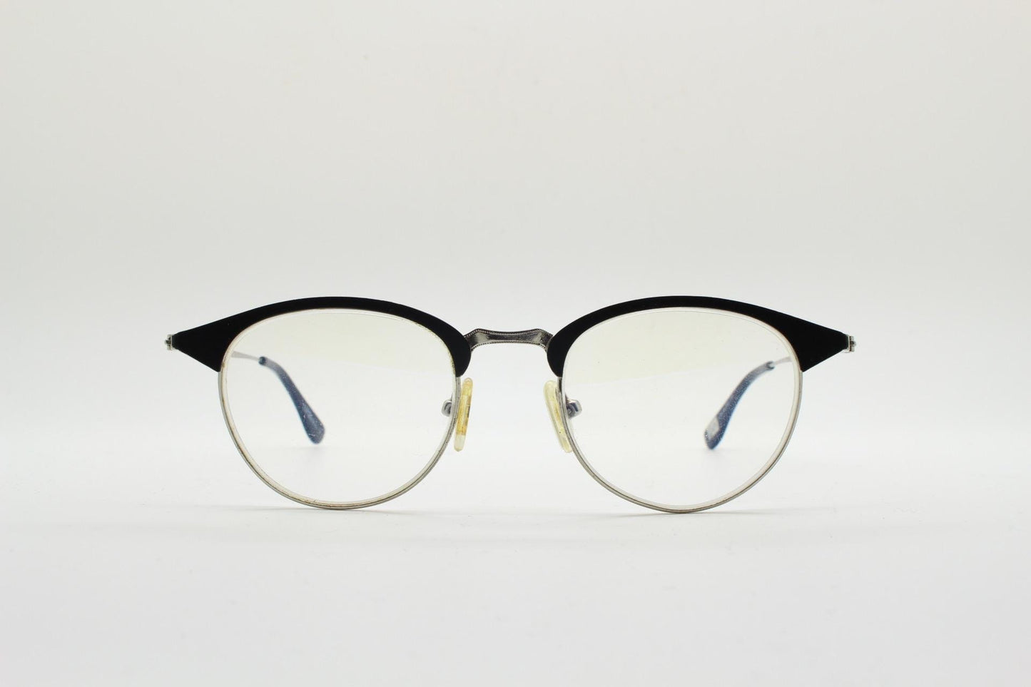 Lupo and Co round eye glasses with pointed corners. Flat metal silver optical frames with black browline. Prescription eyeglasses. RX