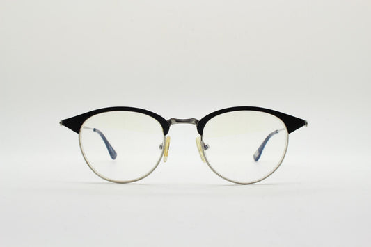 Lupo and Co round eye glasses with pointed corners. Flat metal silver optical frames with black browline. Prescription eyeglasses. RX