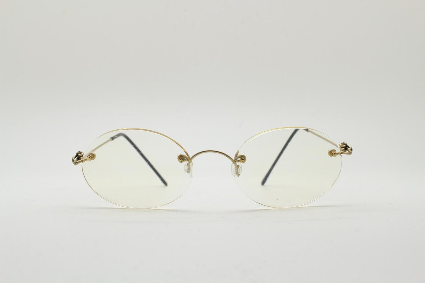 TRY vintage oval frameless eye glasses made in Italy. Futuristic minimal lightweight gold titanium optical frame. RX Spectacles