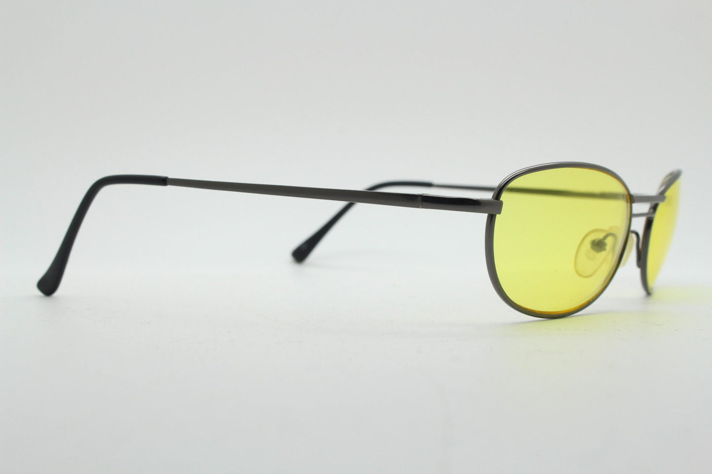 Y2K vintage small oval bug eye sunglasses. Gunmetal grey satin finish frame with blazing canary yellow lenses. Unused 2000s NOS. 90s micro