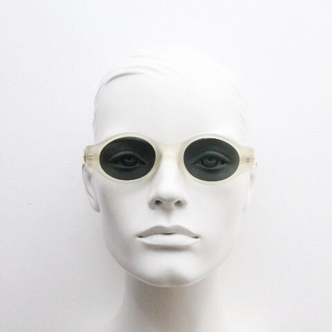 Vintage 90s oval transparent sunglasses. Frosted frame with dark green lenses and heart shaped chain link arms. Unworn NOS