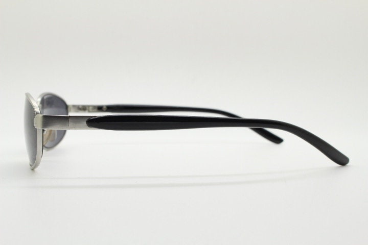 90s vintage small bug eye rectangular sunglasses. Satin finish silver frame with black gloss arms. Unused. 2000s. NOS