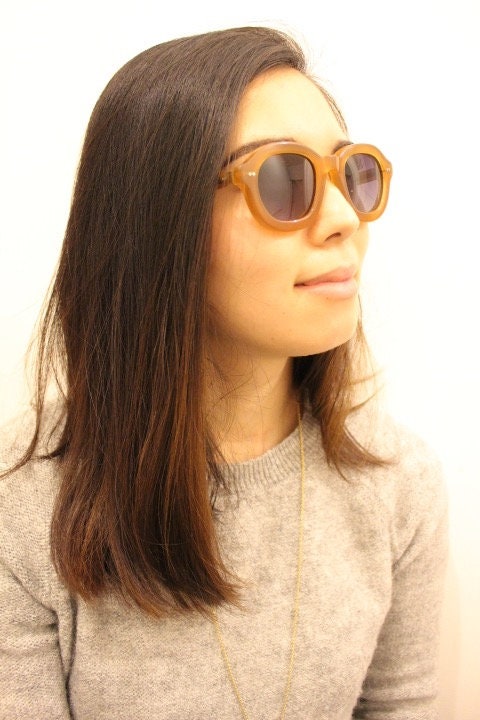 Kopajos thick framed round sunglasses. Hand made transparent amber acetate chunky frame with contrasting graduating lenses