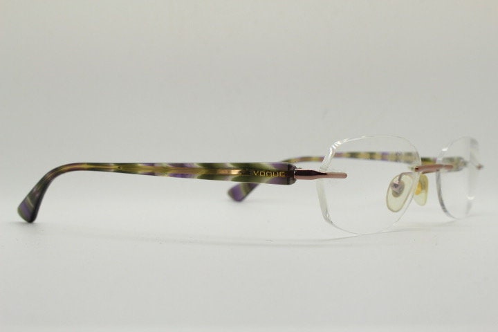 Vogue vintage frameless oval eye glasses. Transparent acetate arms with purple and green tones. Minimal Prescription RX Optical frame