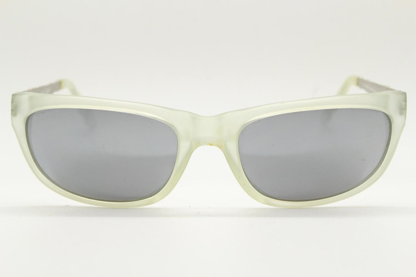 Dakota Smith vintage 90s futuristic sunglasses. Transparent frosted wrap around shield frame with mirror lenses and ornate arm patterns