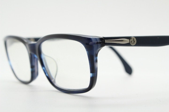 Calvin Klein rectangular low profile eye glasses. Dark navy blue gloss acetate optical frames. Prescription eyeglasses. RX