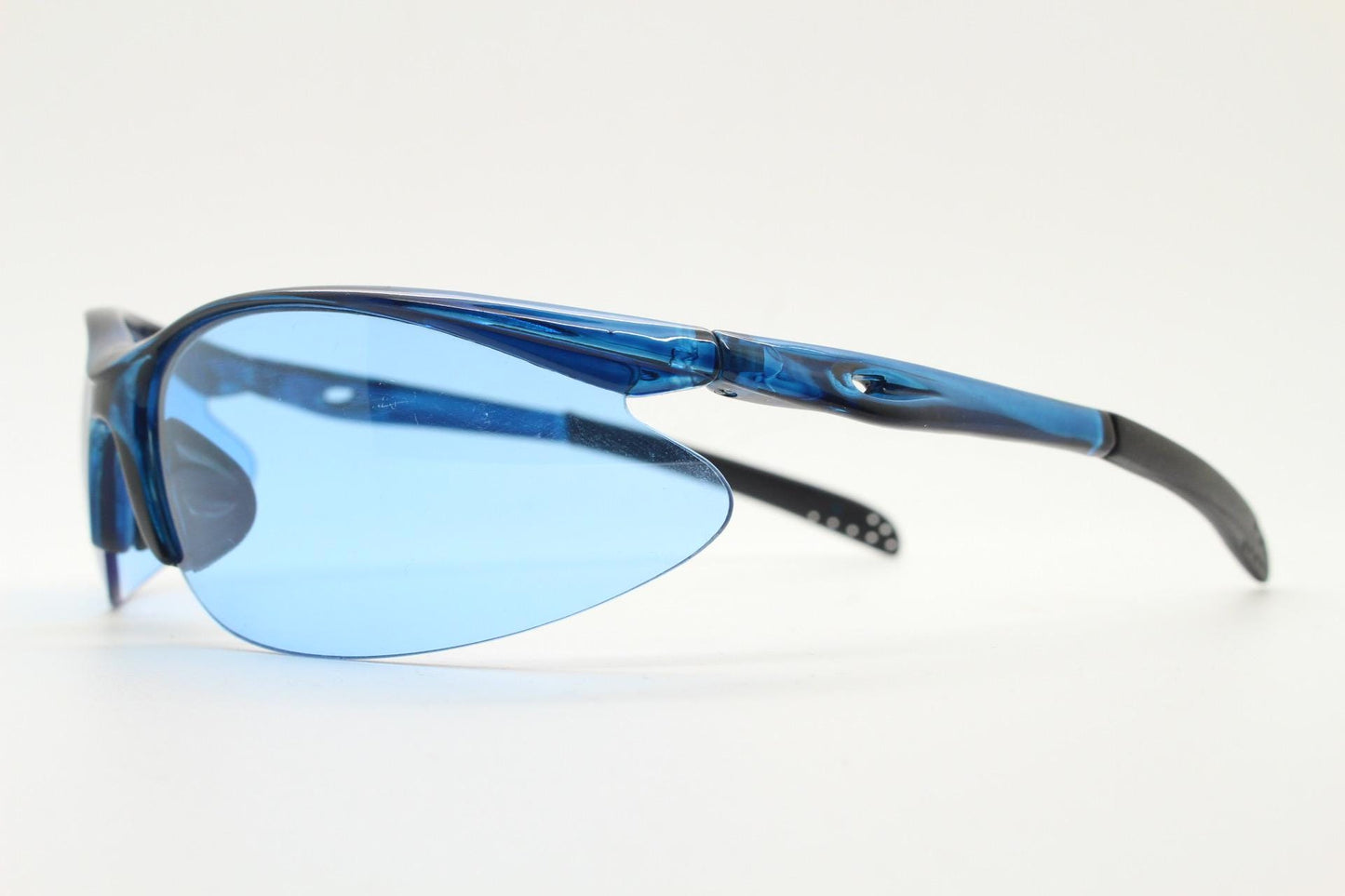 Y2K vintage sport shield sunglasses. Transparent blue frame wraparound aerodynamic visor with matching lenses. 2000's. 90s