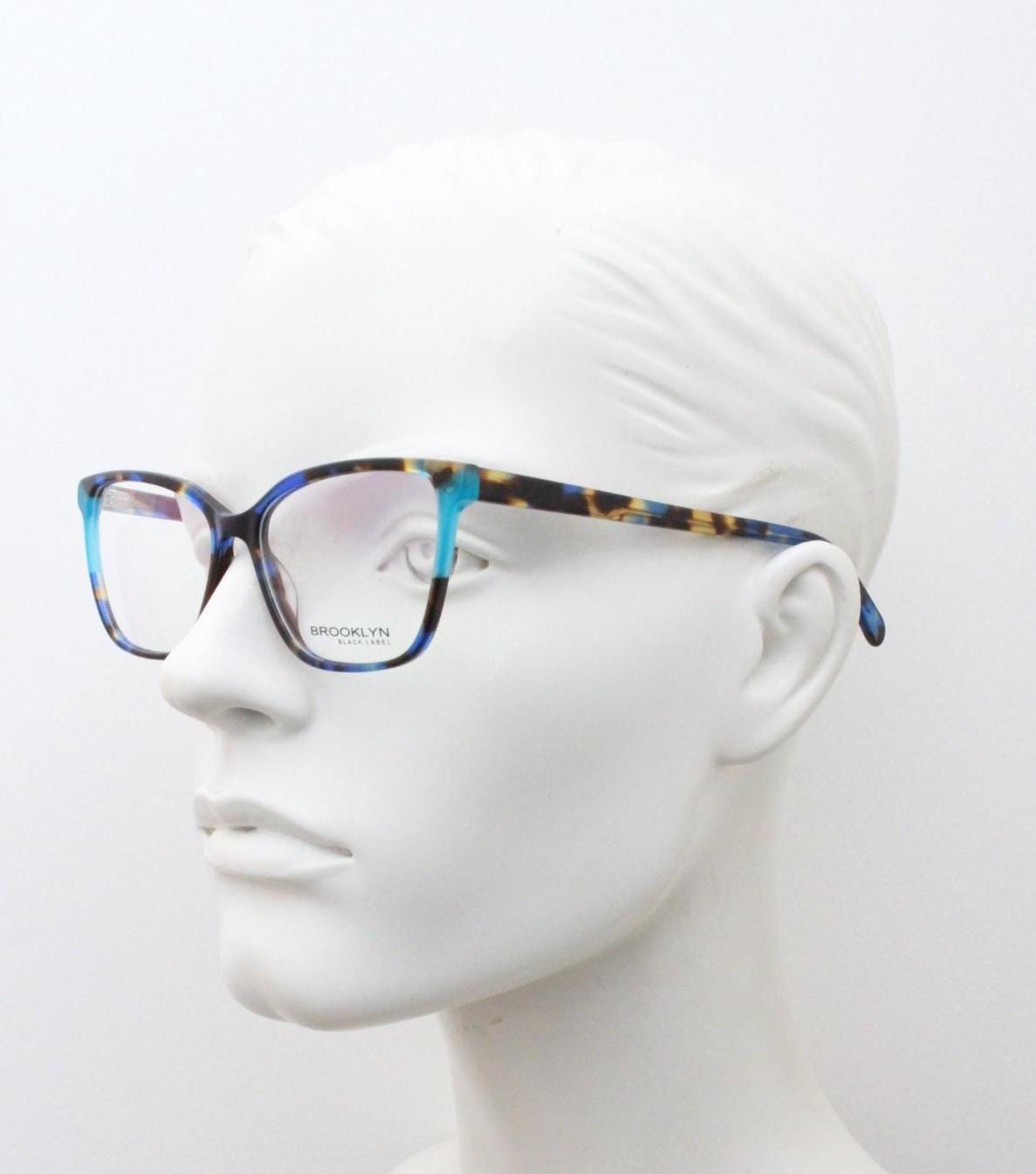 Modified cat eye glasses by Brooklyn. Vibrant blue and brown tones gloss optical frames.  Prescription eyeglasses. RX cateye spectacles