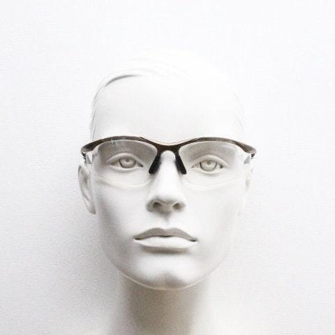 Bolle 90s vintage sports shield sunglasses. Aerodynamic clear lens wrap around half frame design in satin finish with tie string. Cycling