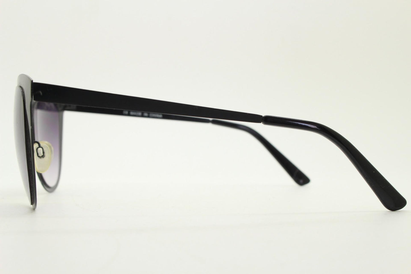 Vintage pointed cat eye sunglasses. Flat metal frame in a satin finish encasing smoky grey graduating lenses. Womens cateye