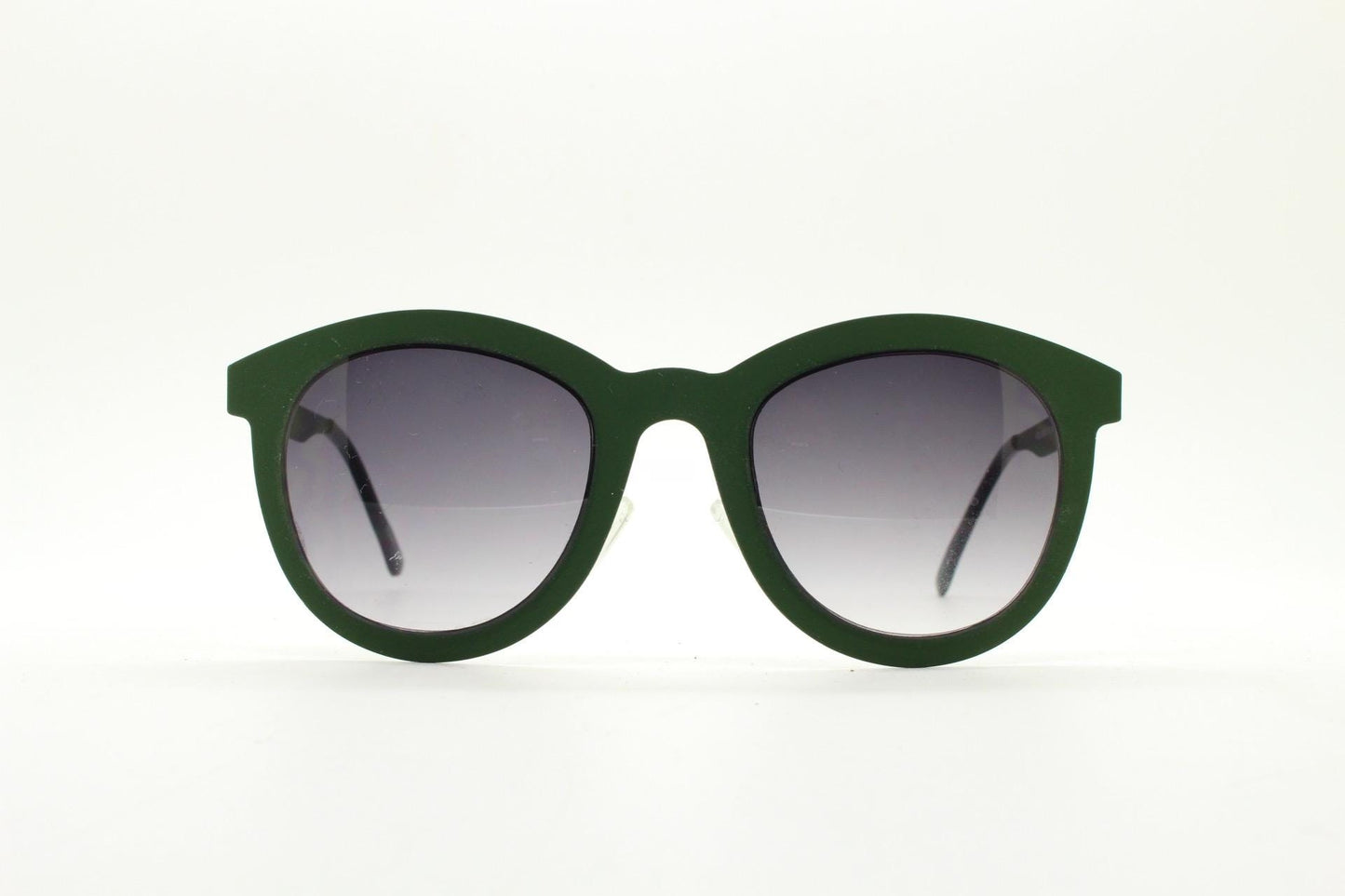 Round vintage cat eye sunglasses. Green flat metal frame in a slightly rubber finish that encases the lenses. Womens 2000s modified cateye