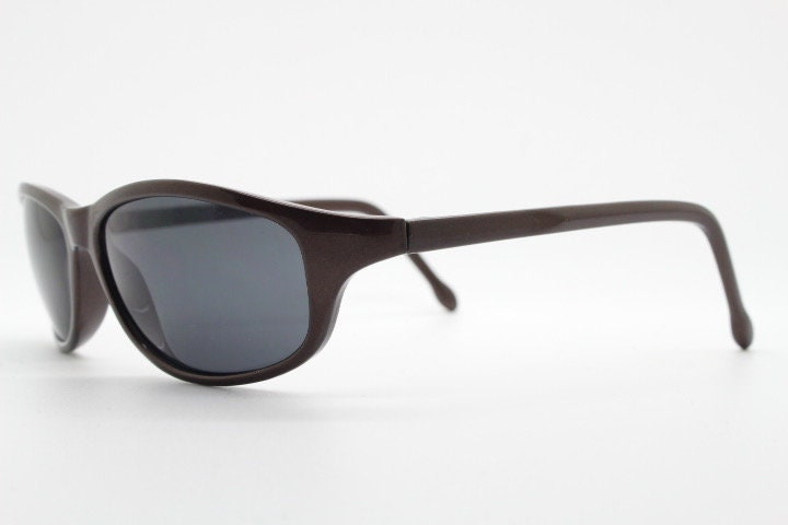 Y2K vintage wrap around shield sunglasses. Brown aerodynamic high gloss frame with black curved lenses. 2000's sport. New Old Stock 90s