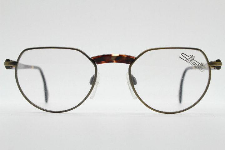 Silhouette vintage 90s flat top oval eye glasses made in Austria. Satin bronze optical frame with honey tortoise trim. Prescription RX