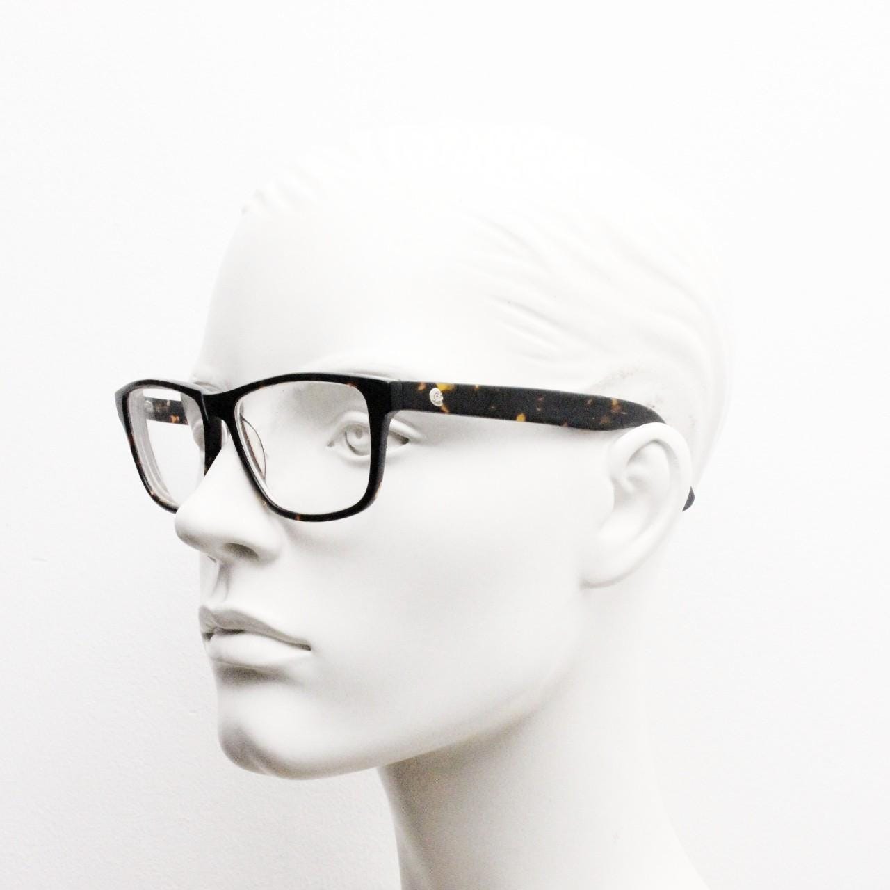Cheap Monday rectangular low profile eye glasses. Dark brown tortoise gloss finish acetate optical frames. Prescription RX spectacles