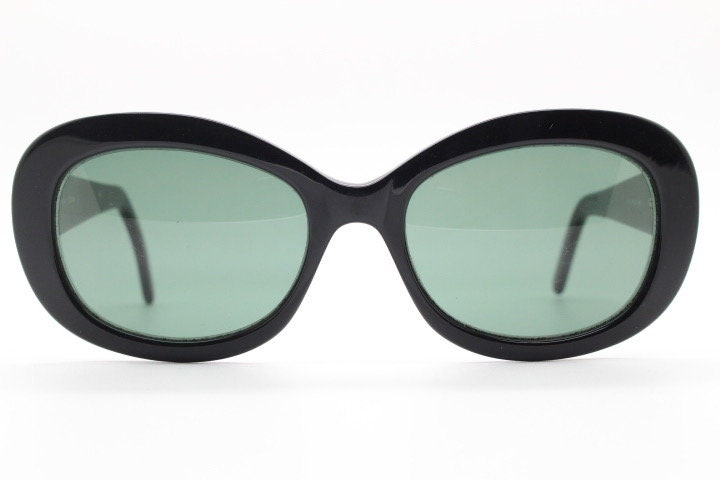 Calvin Klein vintage oval cateye sunglasses made in Italy. Womens plain black gloss thickened acetate cat eye. Classical 60s design. Y2K