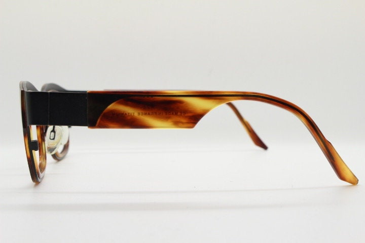 Anne et Valentin rectangular eye glasses hand made in France. Black matt titanium optical frame with mottled brown acetate. Prescription RX