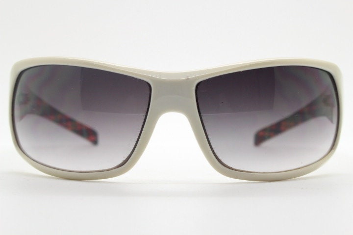 Uvex Y2k vintage wrap around bug eye sunglasses. Curving white sports shield frame with black lenses and tartan interior. Rave 2000s. NOS