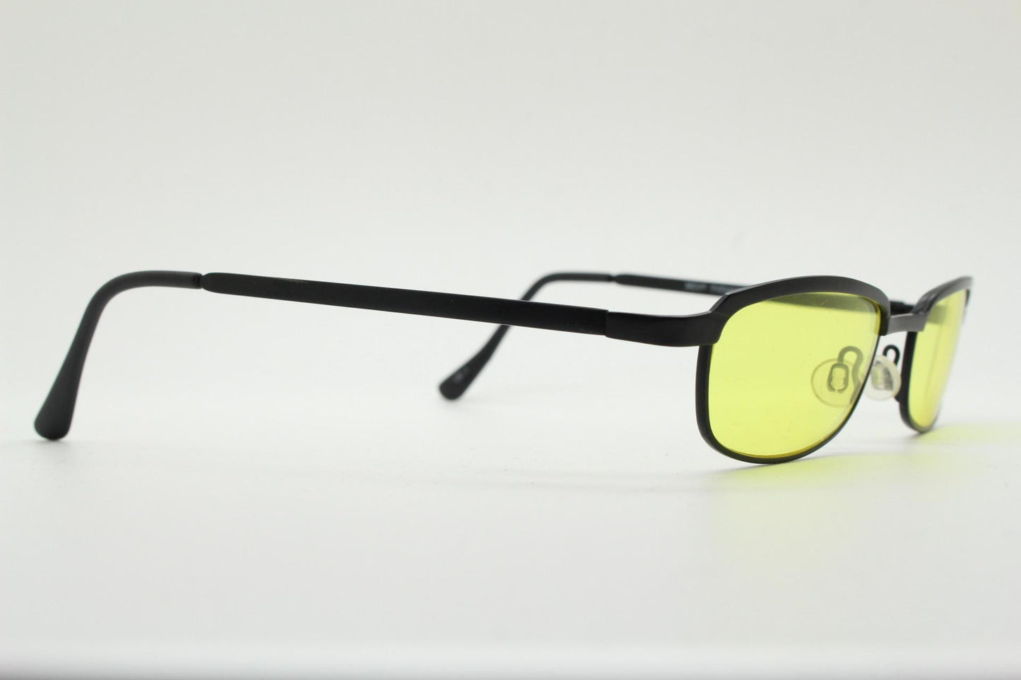 Vintage small rectangular sunglasses. Authentic quirky 90s design in a matt black solid metal frame with bright yellow lenses. 2000s. NOS