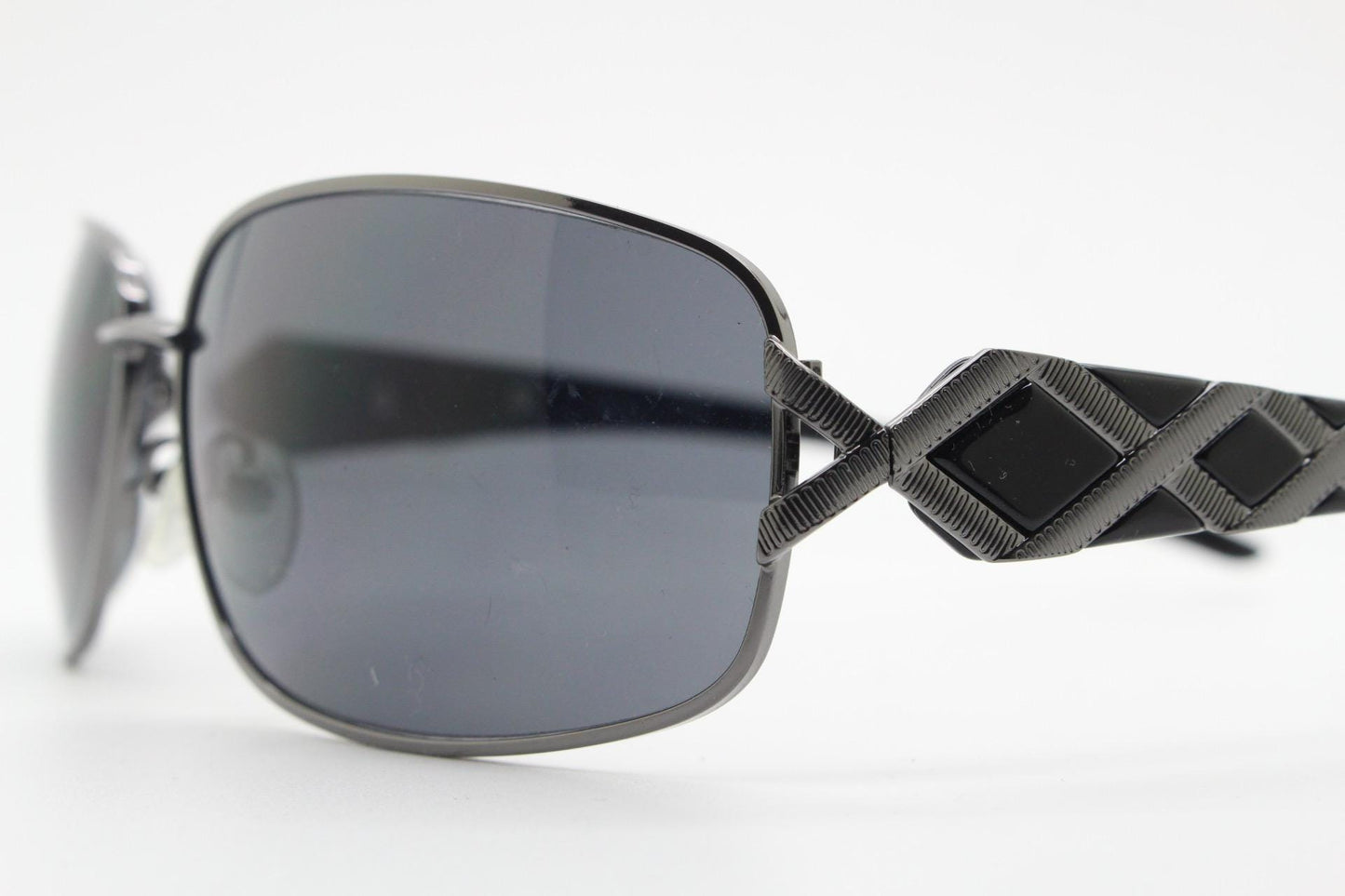 2000s vintage rectangular bug eye sunglasses. Solid metal slightly oversized grey chrome frame with diamond lattice arm detail. Y2K NOS