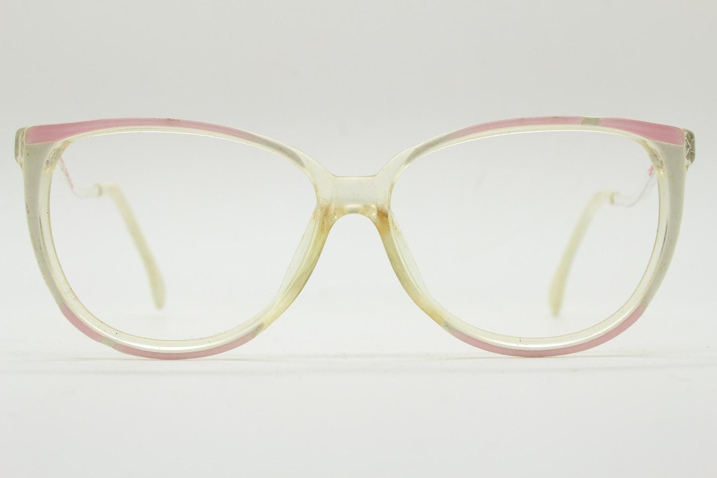 Invicta 80s vintage oversized cat eye glasses made in England. Ice white and pink acetate prescription optical frame with undulating arms