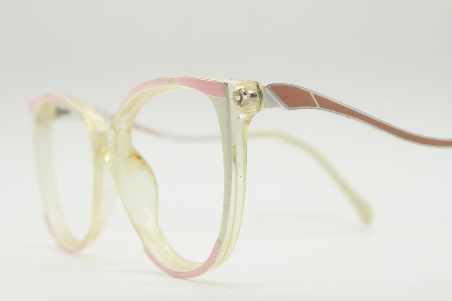 Invicta 80s vintage oversized cat eye glasses made in England. Ice white and pink acetate prescription optical frame with undulating arms