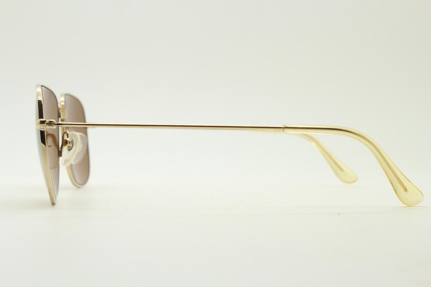 Helmut Lang rectangular 90s vintage sunglasses made in Japan. Minimal gold chrome frame with warm brown lenses. Luxury modified aviator