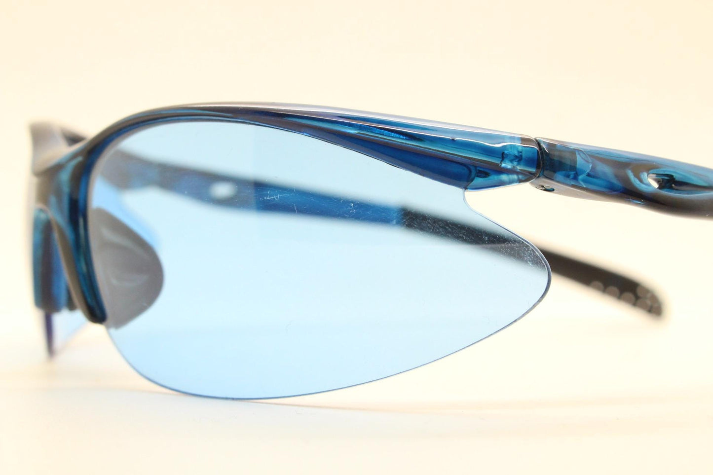Y2K vintage sport shield sunglasses. Transparent blue frame wraparound aerodynamic visor with matching lenses. 2000's. 90s