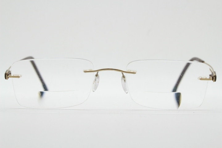 Silhouette rectangular frameless eye glasses model 7677 made in Austria. Minimal lightweight optical frame with golden trim. Prescription RX