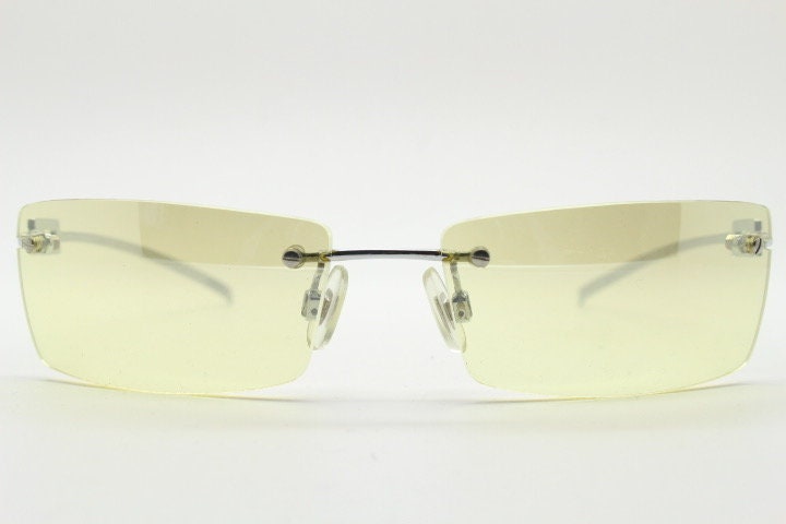 Y2K vintage rectangular sunglasses. Minimal frameless light tone curved mirrored lenses with silver chrome trim. 2000's. 90s. 00s. NOS