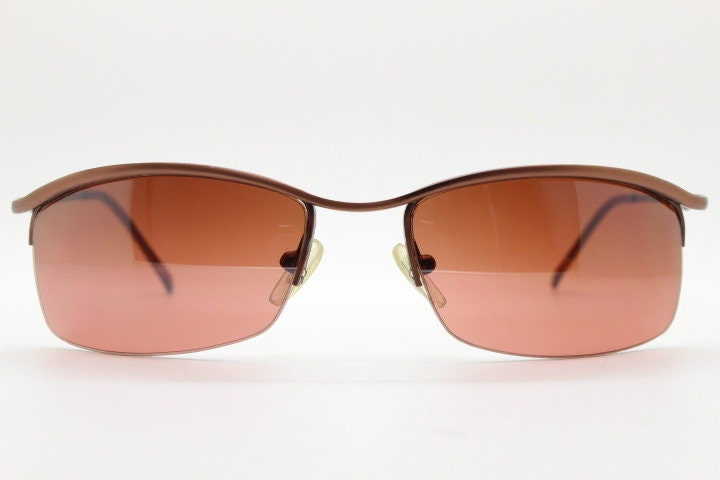Y2K vintage curved rectangular sunglasses. Minimal half frame brow line design in brown satin finish with mid tone lenses. 2000's. 00's NOS