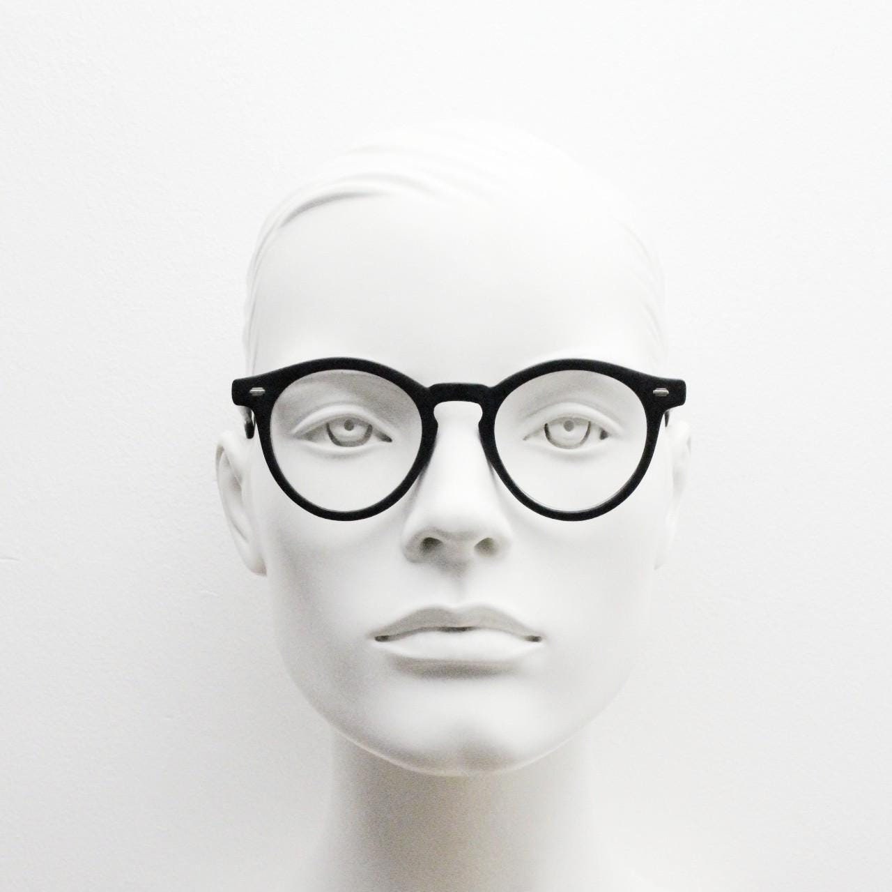 Oliver Smith round eye glasses. Black matt finish optical frames with protruding corners and keyhole bridge. Prescription RX eyeglasses