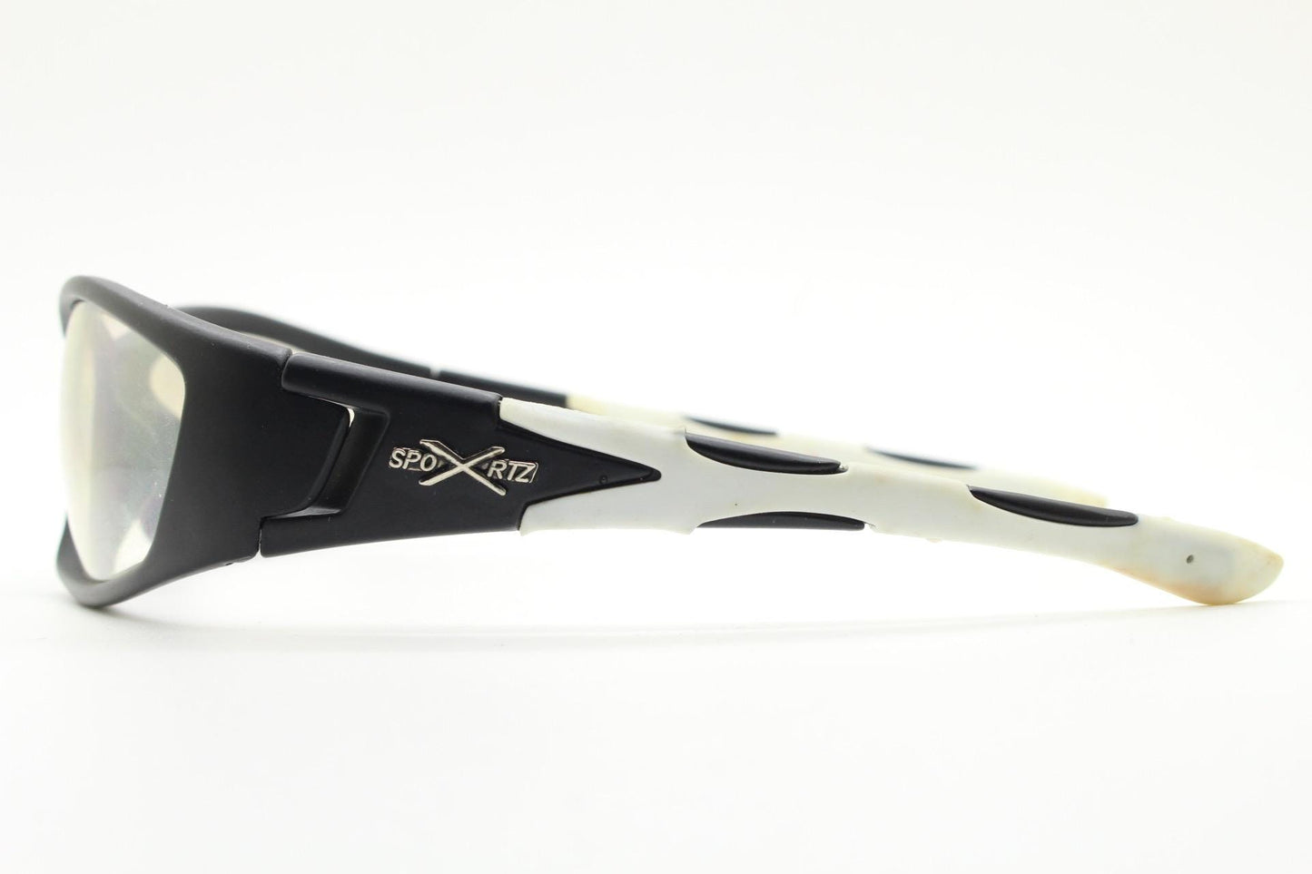 90s vintage sports sunglasses. Black matt aerodynamic wraparound with straight white rubber arms and light tone lenses. Y2K rave shield