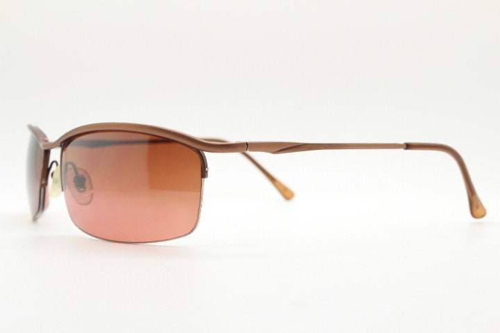 Y2K vintage curved rectangular sunglasses. Minimal half frame brow line design in brown satin finish with mid tone lenses. 2000's. 00's NOS