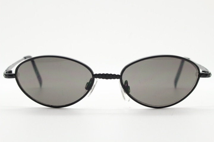90s vintage oval sunglasses. Minimal plain matt black metal frame with unusual indented arm patterns. Unused NOS