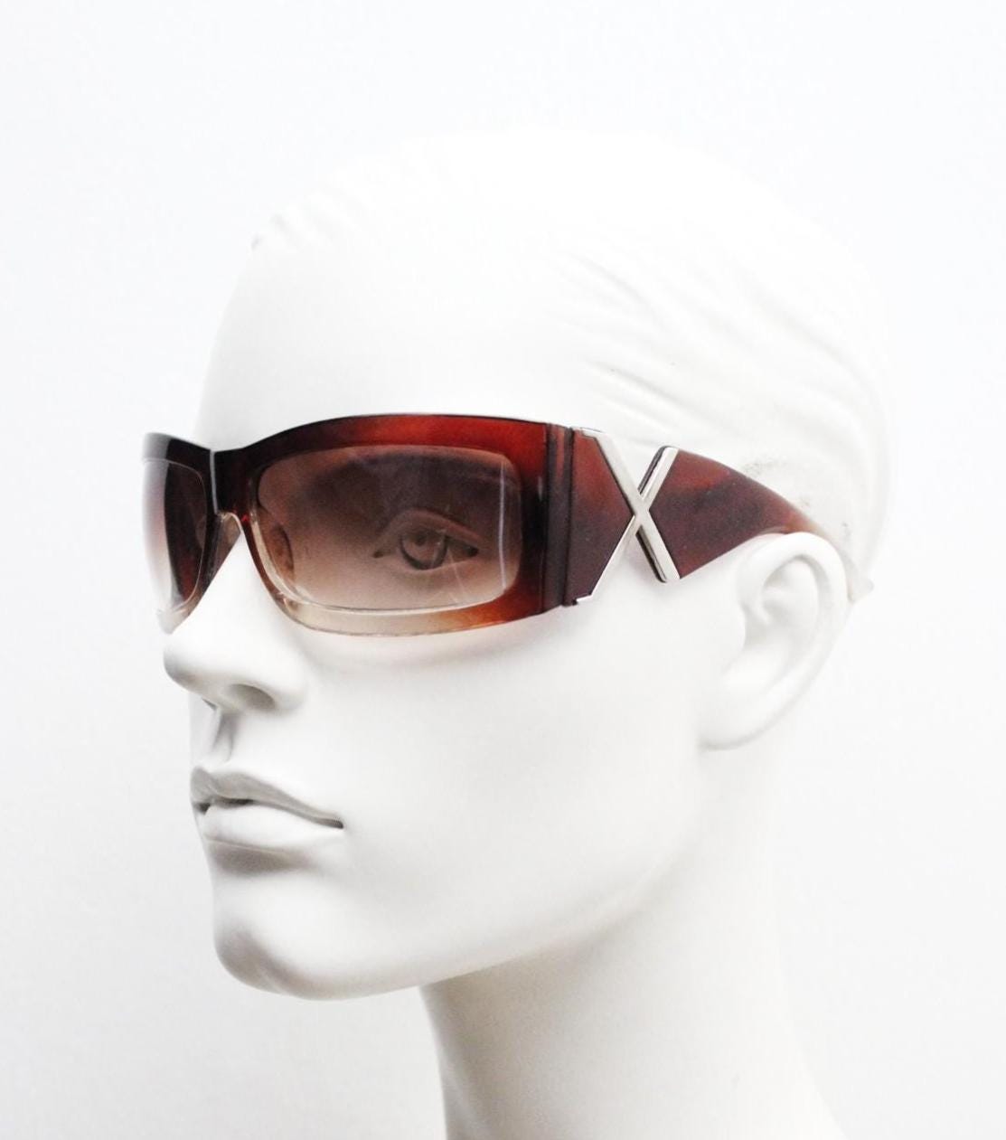 Y2K vintage big wrap around sunglasses. Transparent brown shield design with hot graduating lenses and big X crest. 2000s bug eye. NOS