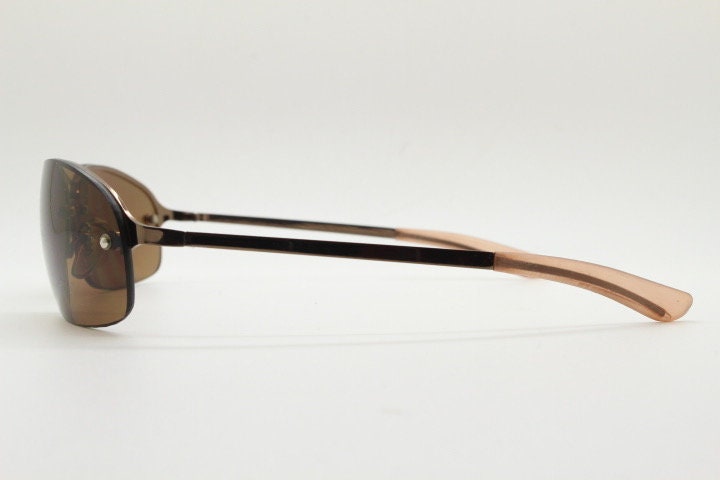 Y2K vintage oval aviator sunglasses. Metallic brown chrome half frame with mid tone curved bug eye lenses and straight arms. 2000's. NOS