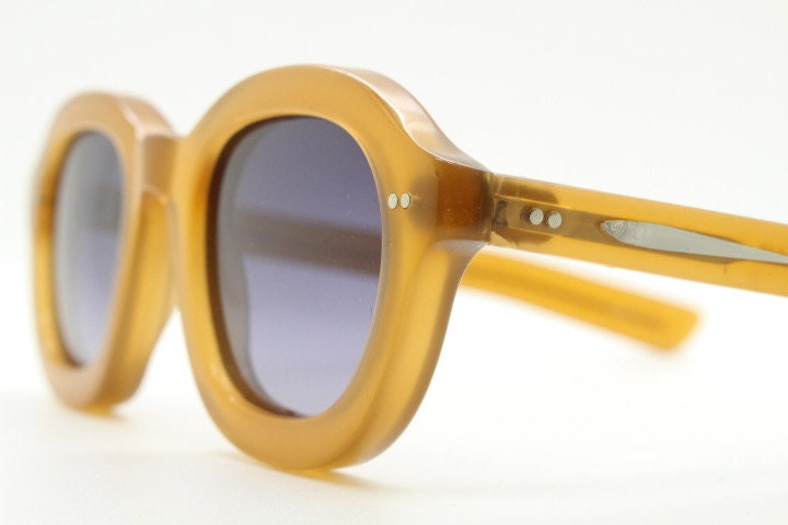 Kopajos thick framed round sunglasses. Hand made transparent amber acetate chunky frame with contrasting graduating lenses