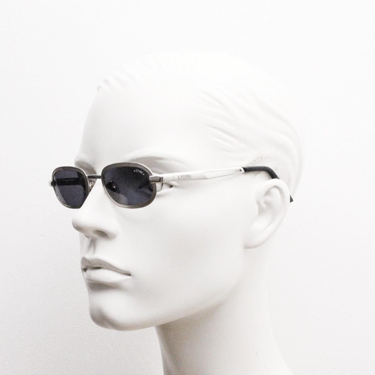 Sting 90s vintage oval sunglasses. Minimal 'Industrial tech' style in slightly small proportions that's quirky but in a quality finish