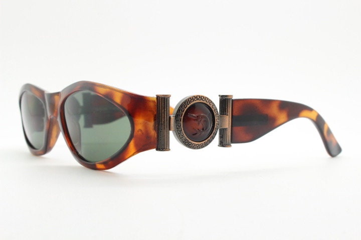 90s vintage oval sunglasses. Low profile transparent tortoise frame with massive bronze metal arm crests BNWT. Unused NOS