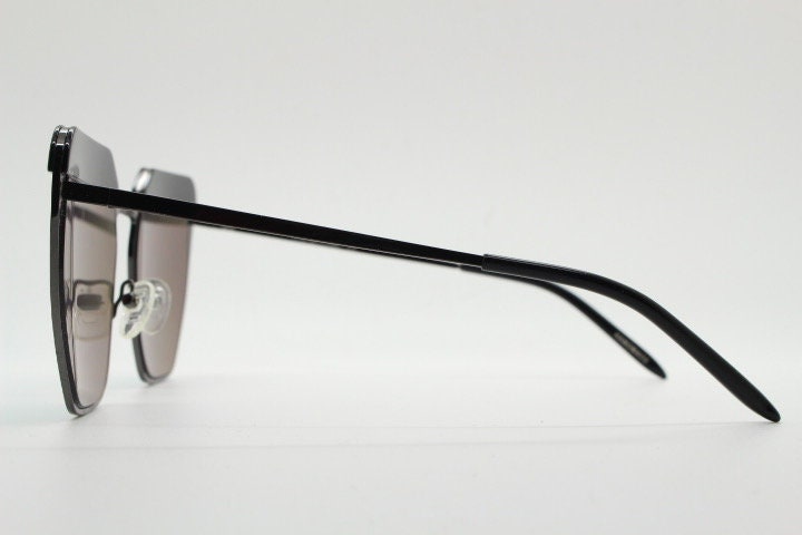 For Arts Sake angular cat eye hand made sunglasses. Black flat top 'eyebrow' design with blue mirror lenses and gunmetal grey frame