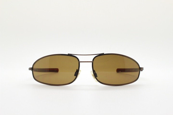 90s vintage abstract rectangular sunglasses. Metallic bronze satin finish frame with brown lenses and straight arms. 2000's. NOS aviator