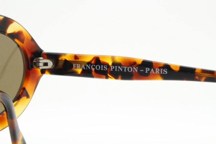 Francois Pinton Paris 90s vintage oval sunglasses made in France. Womens thick acetate frame in brown and amber tones. NOS