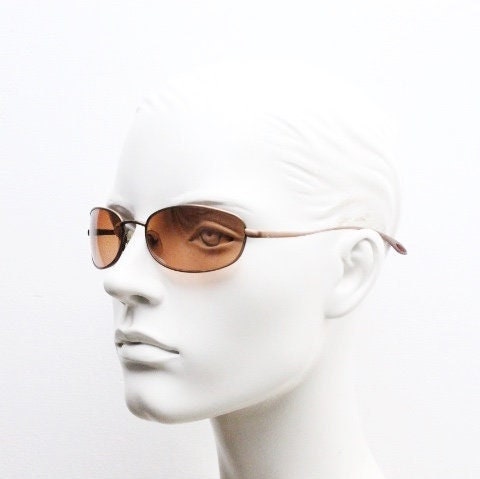 Y2K vintage oval small bug eye sunglasses. Curved copper satin finish metal frame with slender arms. Unused 2000s NOS