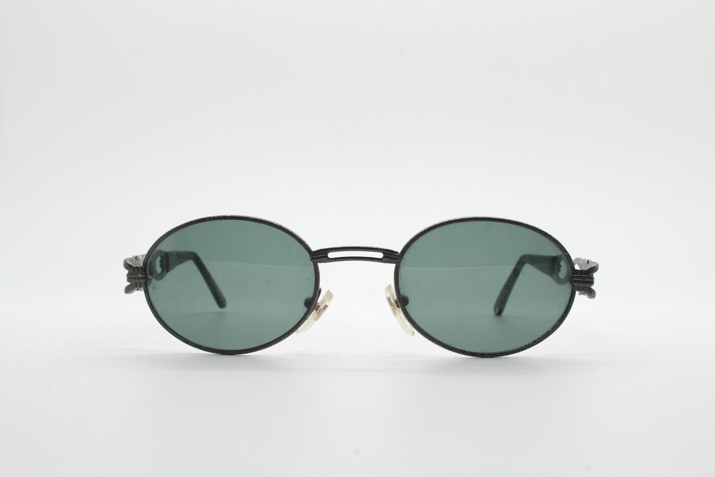 90s vintage low profile oval sunglasses. Authentic Gunmetal grey satin finish frame with chain link arm circles and real glass lenses. NOS